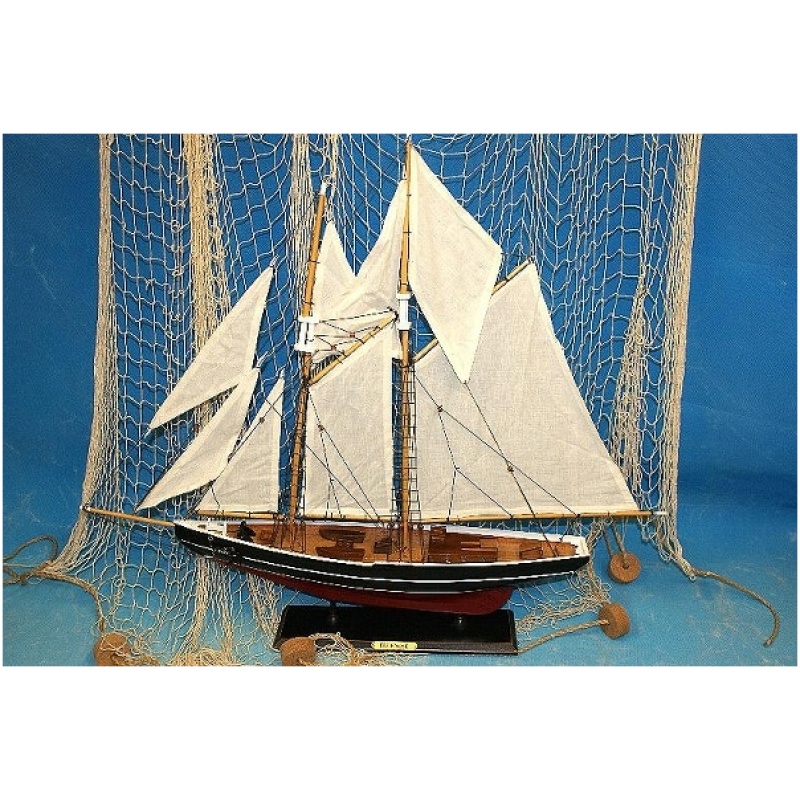 Vor einem Netzhintergrund wird ein detailliertes Modell eines Segelschiffs, bekannt als Segler 2 Master 76x66cm Holz, mit weißen Segeln und dunklem Holzrumpf ausgestellt. Das Schiff ruht auf einem schwarzen Ständer mit der Aufschrift „Schoner“. Der Hintergrund ist blau und unterstreicht das nautische Thema.