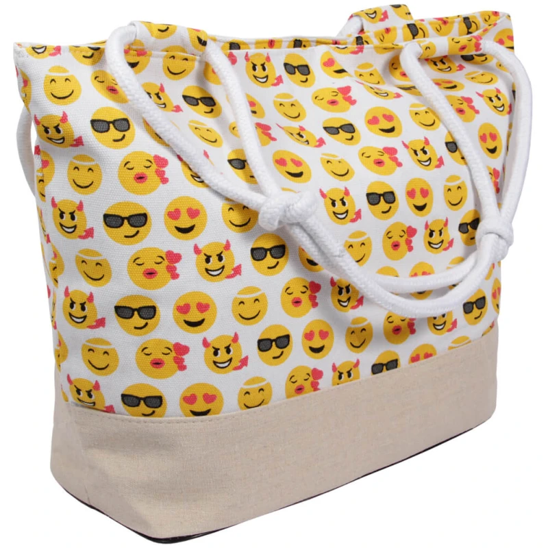 Eine Shopper-Einkaufstasche Strandtasche blau Emoticon ca. 48 cm x 35 cm mit weißen Seilgriffen und einer beigen unteren Hälfte, perfekt als Strandtasche. Der obere Teil der Tasche weist ein buntes Muster mit verschiedenen Emoji-Gesichtern auf, darunter lächelnde, lachende und Sonnenbrille tragende Emojis.