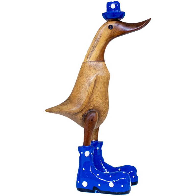 Eine aufrecht stehende Entenskulptur aus Holz trägt einen kleinen blauen Hut und blaue Stiefel mit weißen Punkten. Die Ente hat eine glatte Oberfläche und ein skurriles Aussehen.