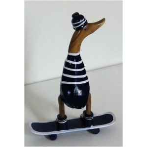 Die Skulptur „Ente auf Skateboard aus Bambus blau/weiss ca 21x10 cm Höhe 28 cm“ ist eine hölzerne Ente, die in schwarz-weiß gestreifte Kleidung, inklusive Beanie, gekleidet ist und auf einem Skateboard mit schwarzen Rädern steht. Die gesamte Figur steht auf einer flachen, weißen Oberfläche.